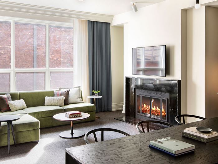 A living room with a fire place at the Kimpton Alexis Hotel